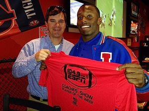 Eric Monroe receives a commemorative Player of the Week T-shirt from ESPN 104.9 Coaches Show host Rob Pearson.