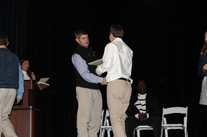 DMS principal Blaine Hathcock shakes the hand of a student during Junior Beta Club inductions earlier this semester.