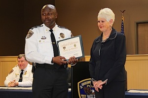 Mary Jo Martin, class president, receiving her certificate from Chief Tommie Reese. In the background is Lt. Tim Soronen, class coordinator.