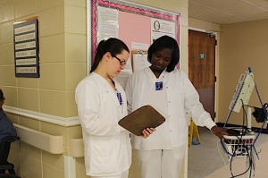 Megan Hill, left, and Zavione Aldrige working at Woodhaven Manor Nursing Home.
