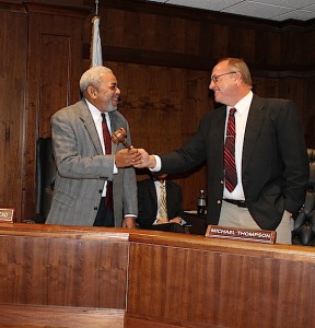 Freddie Armstead, left, accepts the gavel from Michael Thompson.
