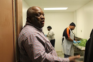 Andrew Williams shows off the Deep South Foods processing facility housed in a building behind the armory. Two workers are preparing collard greens for sale to Red Diamond.