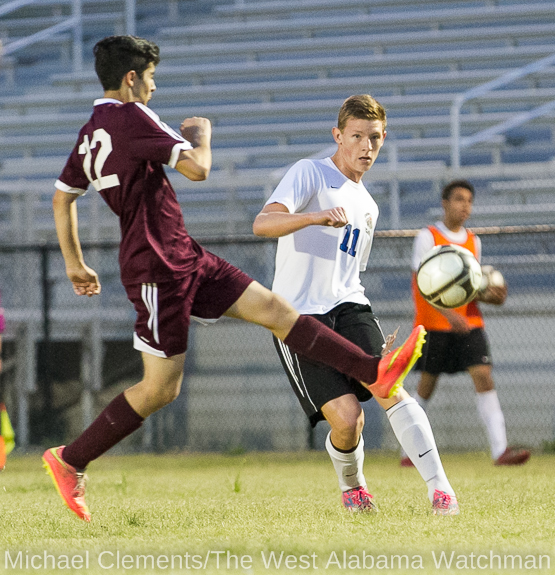 Adam Brooker sends the ball toward the goal, just out of reach of a defender during the 2015 Demopolis High soccer season. Brooker signed to play with UAB.