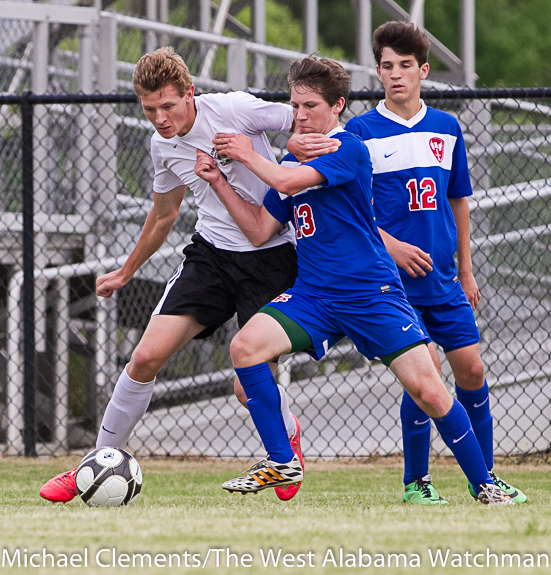 Adam Brooker attempts to fight through the hold of a St. Paul's defender Tuesday.