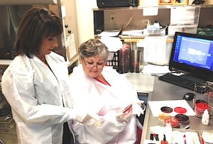 Lab Manager Debbie Green and Tech Cindy Yelverton review test results.