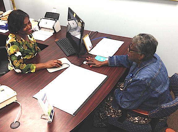 Bryan Whitfield Memorial Hospital employees Annie Jackson and Suzette Russell discuss the Admissions Department’s new fingerprint scanner system.