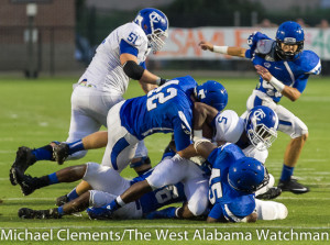 Demopolis' R.J. Cox (42), Erin White (45) and Marcus Wright (26) take down a Tuscaloosa County ball carrier.