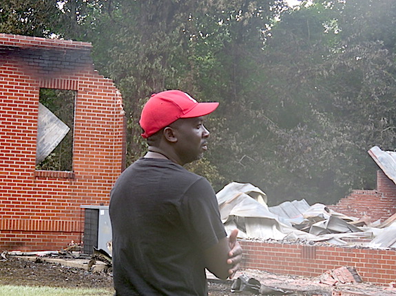 Dewayne Charleston surveys the damage as Gilfield Baptist Church lies in ruins following a fire Tuesday night that burned into the early hours of Wednesday morning. “It may look bad right now, but after a while, God is going to work it out," Charleston said of the circumstances that have befallen the congregation.