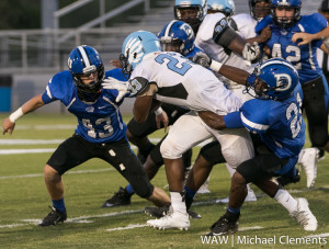 Demopolis' A.J. Collier (21) puts the brakes on a Calera ball carrier as Russ Logan (43) moves in to assist.