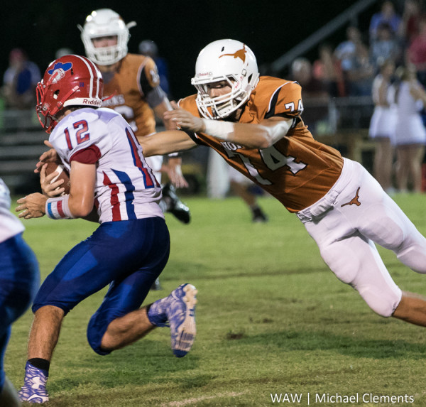 9-17-2015 - Linden, Ala. - Marengo Academy's Austin Eatmon reaches out to tackle a South Choctaw runner.
