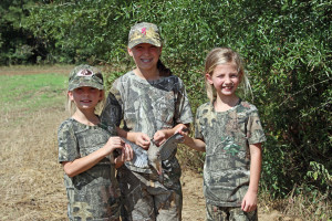 The Yrabedra twins, Haley, left, and Averie, right, and Kylie Powell retrieve another dove for the families' hunting party. (Photo by David Rainer)