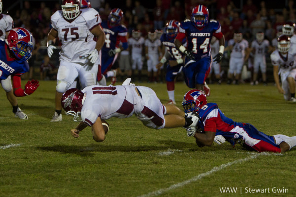 9-18-15 -- Linden, Ala. -- Maplesville QB Cole Spencer (11) is tackled by Linden's Henry Lee (9). Linden fell to Maplesville, 20-7. 