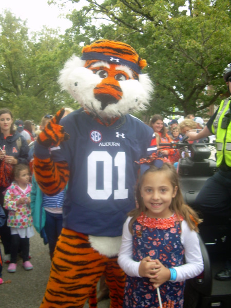 Riley Windham was able to attend her first Auburn game over the weekend. Shown here, she was able to meet Aubie during the Tiger Walk. (Photo by Emily Windham)