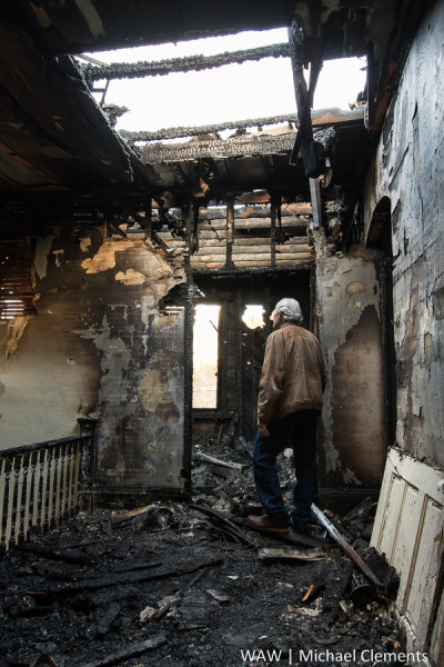 Demopolis, Ala. - 1-6-2015 - Arthur Ogden surveys the damage from the fire that destroyed part of the Ogden's home on Monday, January 4, 2015.