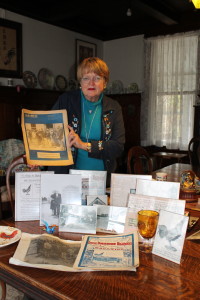 Patsy Derby Chaney shows memorabilia from the 1919 rooster auction in Demopolis. (Contributed Photo)