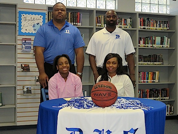 Courtney Hill alongside her mother Sanyvette Hill and DHS girls basketball coaches Ronnie Abrams and Tony Pittman