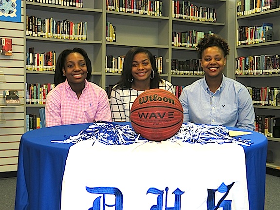 Demopolis Lady Tiger basketball players Courtney Hill, Ivery Moore and DeeDee White signed scholarships to Alabama junior college programs Friday.