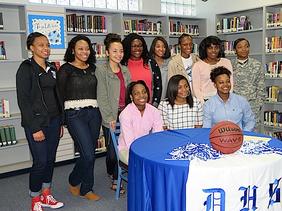 The Demopolis High School girls basketball team celebrates with senior signees Courtney Hill, Ivery Moore and DeeDee White.