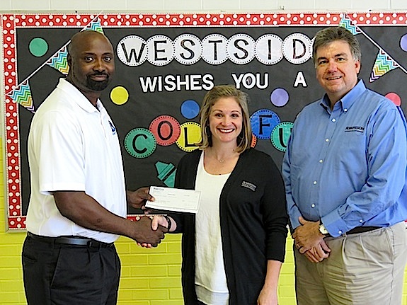 Westside Elementary School principal Tony Pittman receives a $1,400 check from Robertson Banking Company's Katie Windham and Allen Bishop.