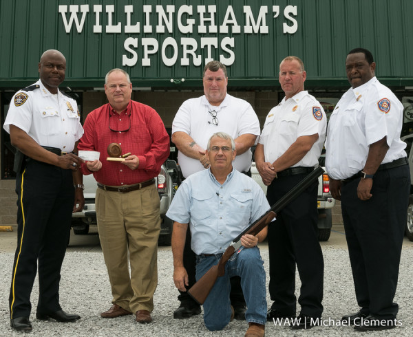 5-26-2016 - Demopolis, Ala. - West Alabama Charity Clays presented the Demopolis Police and Fire Departments with a check for Demopolis Police and Fire Departments' Childrens Christmas Fund. Pictured are (kneeling) Ronnie Willingham of Willingham's Sports and (standing) Demopolis Police Chief Tommie Reese, John Scales of Collins Communications, DPD Lieutenant Tim Sornonen, DFD Batallion Chief Michael Pope and Demopolis Fire Chief Vernon Waters.