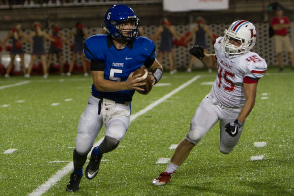 08-18-16 -- Montgomery, Ala. -- Demopolis QB Logan McVey (5) looks to get past Hillcrest's Ben Parker (45) in Thursday's Champions Challenge at the Crampton Bowl in Montgomery, Ala. (WAW | Stewart Gwin)