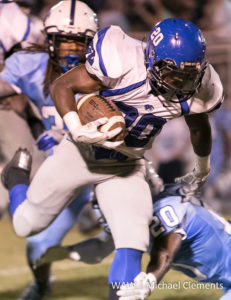 9-16-16 -- Calera, Ala. -- DHS Tigers RB A.J. Besteder (20) makes a cut to shed a tackler against the Calera High School Eagles.