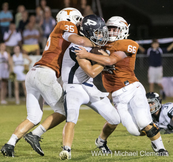 9-22-16 -- Linden, Ala. -- Marengo Academy's Weldon Aydelott (35) and Collin Sheffield (660 wrap up a Patrician Academy ball carrier during the Longhorns' victory over the Saints. Aydelott also paced the offense with 214 yards and four TDs.