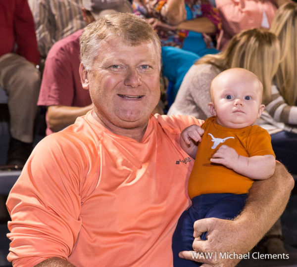 With a little help from grandpa Eddie Freeman, Brady Flowers shows his support for the Longhorns at Marengo Academy's homecoming game.