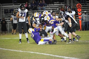 (Photo by Johnny Autery) A host of Bulldogs defenders crush the Fruitdale QB.
