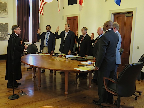 The Demopolis City Council and Mayor John Laney take the oath of office from Judge Vince Deas Monday morning.