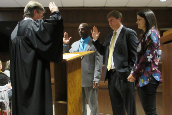 District Judge Vince Deas, left, administers the oath of office to Calvin Martin, center, and Jason Windham. (WAW | Jan McDonald)