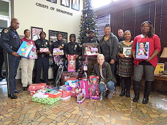 The Demopolis Police Department presents gifts to Crystal Williams to brighten Christmas for her three daughters Camrion, Alexi and Caitlyn. 